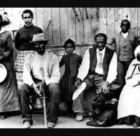 The "Conductor," Harriet Tubman (on left), with slaves she rescued, at a station on the Underground Railroad.