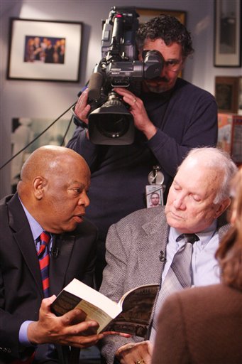 John Lewis, D-Ga, left, gives Elwin Wilson of Rock Hill, S.C., a copy of Lewis' book in the congressman's Washington, D.C. office, while taping an interview for ABC's "Good Morning America."