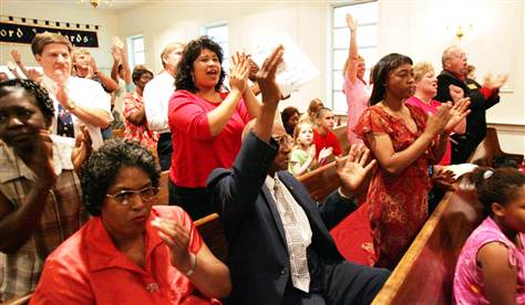 Engene Crawford, center, grandson of lynching victim Anthony Crawford, and his family react during a reconciliation service at Friendship Worship Center Tuesday in Abbeville, S.C. (Mary Ann Chastain  /  AP)