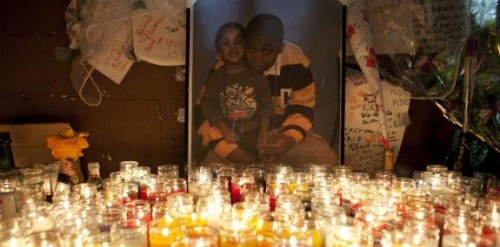 Photo of Kimani Gray and his younger sister is illuminated by candles at memorial, March 13, 2013. (Allison Joyce/Getty Images)