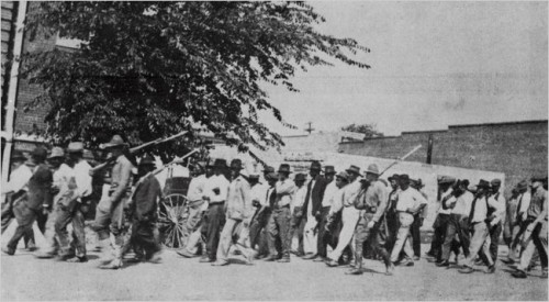 Black men marching to the jail to protect Rowland from being lynched, before the start of the race riot. (Tulsa Historical Society)