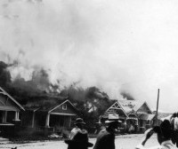 Homes of African Americans burning during the race riot. (Tulsa Historical Society.)