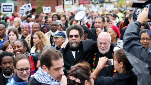 Author and activist Cornel West (center), members of the clergy and other demonstrators protest outside the Ferguson, Mo., police station on Oct. 13, 2014. 