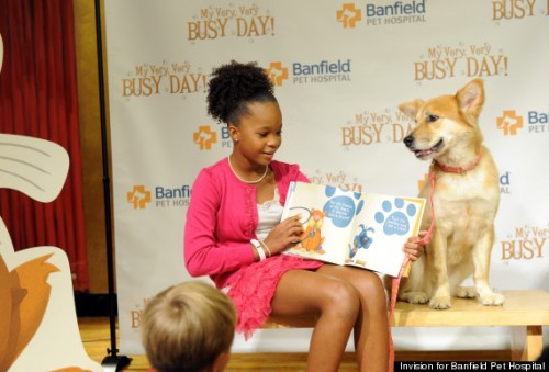 Quvenzhane Wallis, joined by her four-legged co-star, Sandy, reads aloud from Banfield Pet Hospital's first-ever children's book, "My Very, Very Busy Day," at a book launch event at the Children's Museum of Manhattan, on Oct. 15, 2014, in New York City.