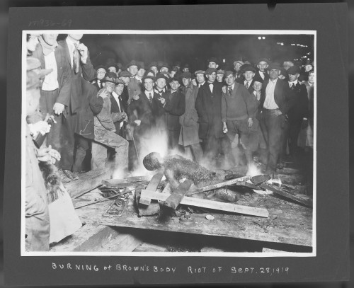 The lynching crowd poses as Brown's body burns. No one served time for their participation in the riot or lynching. Brown was buried in a pauper's grave. His death was recorded in a log with just his name and the word "Lynched."