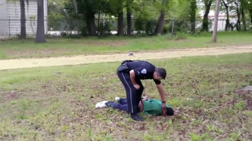 In this image from video, police officer Michael Thomas Slager checks on Walter Scott after he was shot by Slager in Charleston, S.C., on April 4, 2015. (Feidin Santana via AP Images)