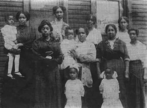 Baby Jimmie Cameron in his mother Vera's arms, surrounded by female relatives in LaCrosse, Wisconsin, 1914.