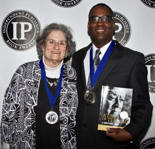 Fran Kaplan (L) and Reggie Jackson (R) accepting the Silver IPPY medals on May 10, 2016, in Chicago. They are two of four authors who contributed the additional materials included in A Time of Terror's 3rd edition.