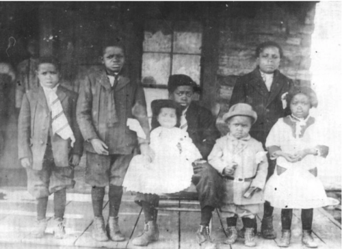 Creek Freedmen Ron Graham’s father, Theodore Graham, center, as a youth with his youngest sibling, Rowena, on his lap, in a photograph from around 1912. Mr. Graham spent decades assembling documentation showing that he is a citizen of the Muscogee (Creek) Nation.