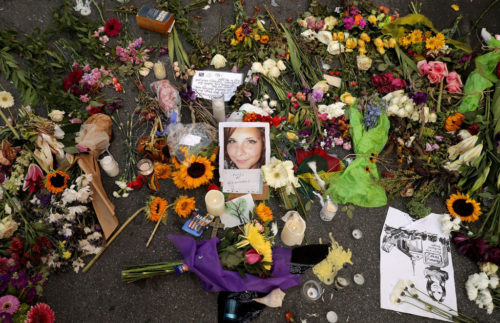 CHARLOTTESVILLE, VA - AUGUST 16:  Flowers, candles and chalk-written messages surround a photograph of Heather Heyer on the spot where she was killed and 19 others injured when a car slamed into a crowd of people protesting against a white supremacist rally, August 16, 2017 in Charlottesville, Virginia. Charlottesville will hold a memorial service for Heyer Wednesday, four days after she was killed when a participant in a white nationalists, neo-Nazi rally allegedly drove his car into the crowd of people demonstrating against the 'alt-right' gathering.  (Photo by Chip Somodevilla/Getty Images)