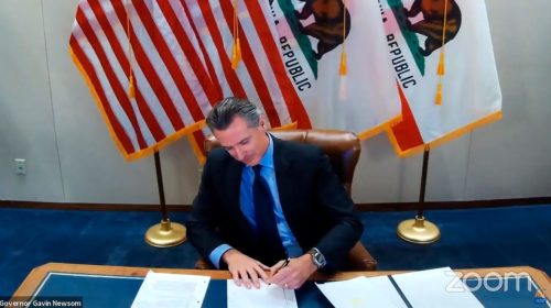 Governor Newsom signing bill into law