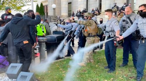 001 Graham protesters pepper sprayed on their way to vote