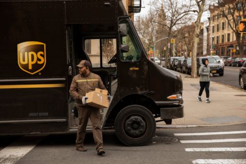 A UPS driver making a delivery in Brooklyn. The company has eliminated rules against facial hair.Credit...Benjamin Norman for The New York Times