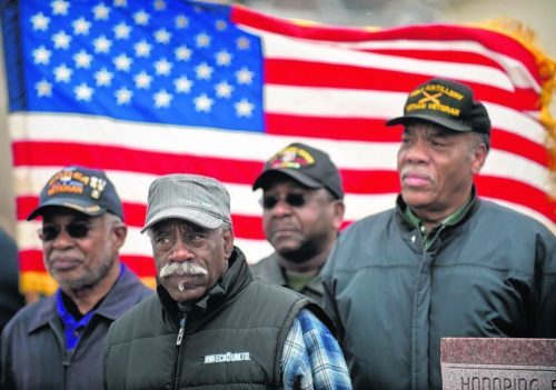 Black veterans of the Vietnam and Korean Wars, all of whom received the Purple Heart medal during their service, stand together during a ceremony, organized by American Legion Post 16 and the City of Lynchburg, honoring their sacrifice 