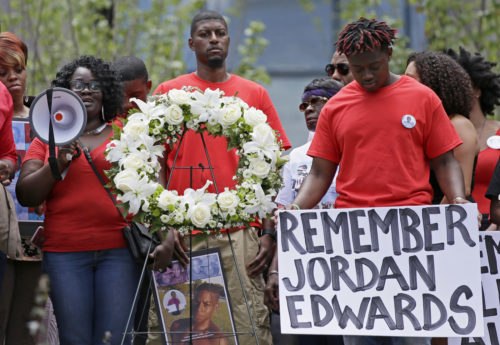 FILE - In this May 13, 2017, file photo, slain teen Jordan Edwards' mother Charmaine Edwards, left, speaks to supporters with son Vidal Allen, right, and husband Odell Edwards during a protest outside the courthouse in Dallas. The trial of former officer Roy Oliver, indicted on a murder charge, is scheduled for August 2018 in the shooting death of Jordan Edwards, a 15-year-old who was riding in a car with four other black teenagers, one of the high-profile cases in recent years in which police were charged with shootings of black people. (AP Photo/LM Otero, File)