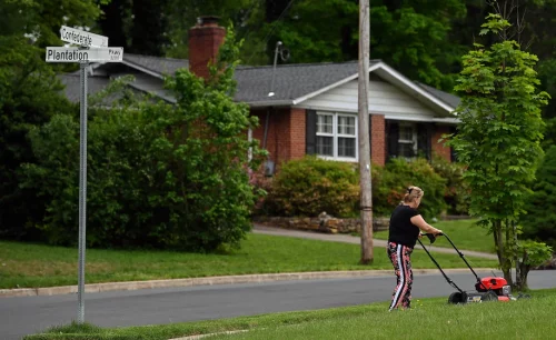 A resident at the corner of Confederate Lane and Plantation Parkway in the Mosby Woods neighborhood of Fairfax. (Michael S. Williamson/The Washington Post)