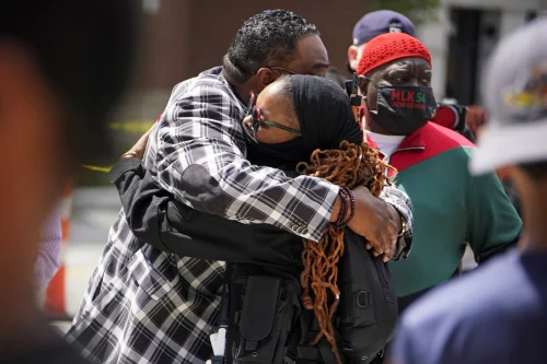 People hugging outside the Akron Civic Center after a viewing for Jayland Walker on July 13. (Gene J. Puskar / AP file)