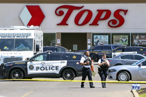 Police walk outside the Tops grocery store in Buffalo, N.Y. on May 15.Joshua Bessex / AP file
