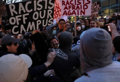 A man wearing a Proud Boys shirt fights with protesters ahead of an event featuring far-right group Proud Boys' founder Gavin McInnes at Pennsylvania State University. (Leah Millis/Reuters)