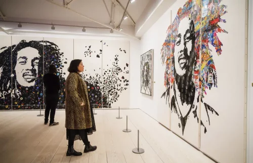 Images of the late reggae pioneer Bob Marley appear at the press launch for the exhibit "Bob Marley One Love Experience" at the Saatchi Gallery in London, which will soon open at Ovation Hollywood in Los Angeles. (Alex Brenner via AP)