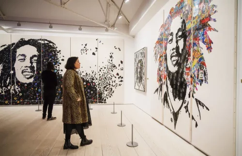 1000 Images of the late reggae pioneer Bob Marley appear at the press launch for the exhibit "Bob Marley One Love Experience" at the Saatchi Gallery in London, which will soon open at Ovation Hollywood in Los Angeles. (Alex Brenner via AP)