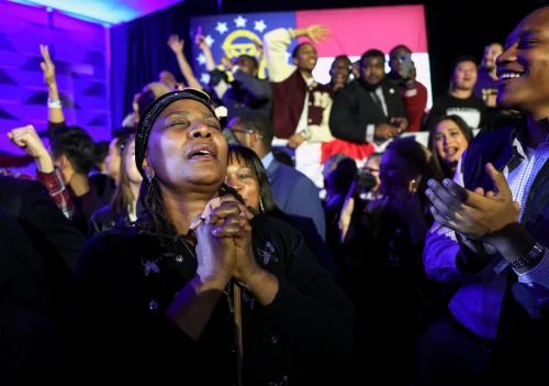 Supporters cheer Tuesday as the Georgia Senate runoff is called for Sen. Raphael Warnock at an election-night watch party in Atlanta. (Win McNamee / Getty Images)