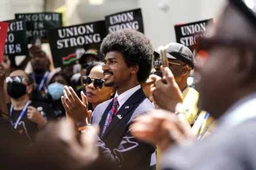 230816-black-history-protest-miami-ew-341p-4fb1e5 Tennessee state Rep. Justin Pearson, D-Memphis, center, listens during a speech at the "Teach No Lies" march Wednesday outside the Miami-Dade County School Board in Miami. Lynne Sladky / AP