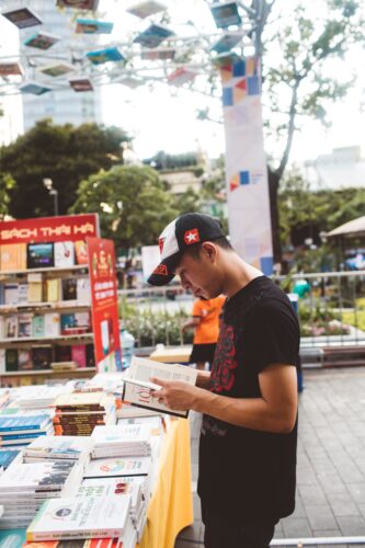 pexels-streetwindy-4130658 Man at a book fair