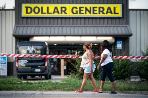 People walk past the Dollar General store in August in Jacksonville, Fla., where three people were shot and killed the day before. (Sean Rayford / Getty Images)