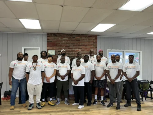 Members of Baltimore Rites of Passage Initiative pose for a photo while being honored for their dedication to mentorship on April 13, 2024 (Mentorship Maryland).