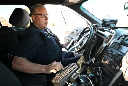 Denver police technician Kurt Barnes prepares to issue a speeding ticket during a traffic stop along North Federal Boulevard in Denver on Nov. 25, 2024. On this particular day, Barnes was targeting drivers driving at least 13 miles over the posted limit of 35. (Photo by Helen H. Richardson/The Denver Post)
