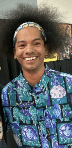 Michael Thweets, a young Black man in button down shirt featuring comic panels