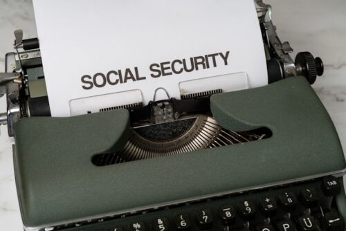 Typewriter containing a sheet of paper reading "Social Security"