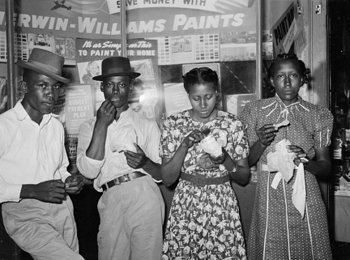 Eating ice cream in front of hardware store.