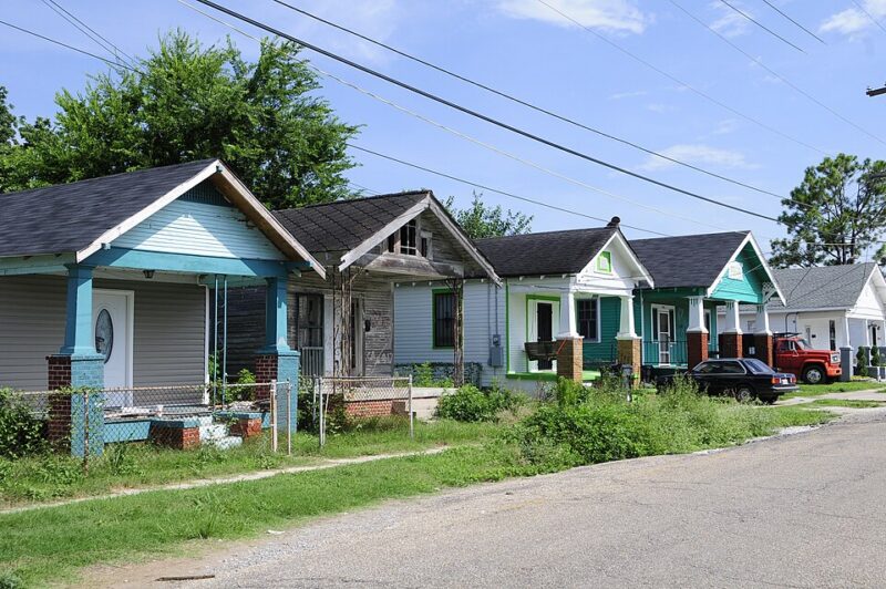 Row of homes on a street, 3 of 5 rennovated