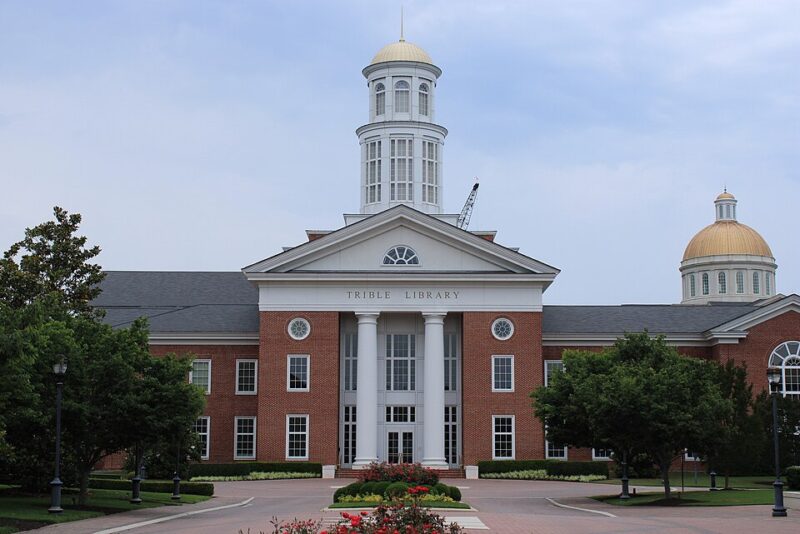 Stately brick building with white columns housing the library at Christopher Newport University