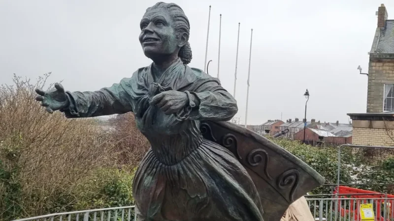 Statute of Mary Ann Macham with arms reaching forward