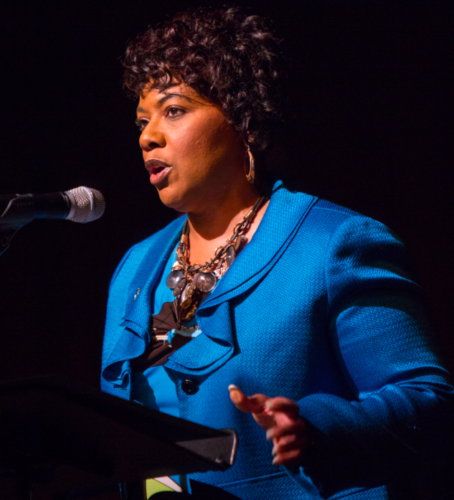 Bernice King in the spotlight in front of a microphone