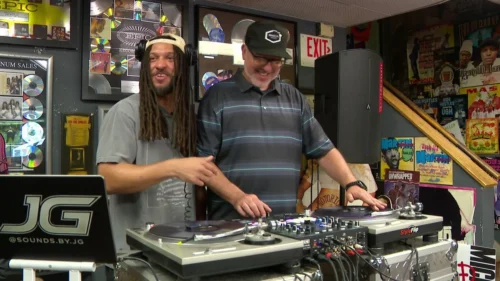 DJ JG passes on his knowledge to WCCO Photojournalist Chris Cruz.  (WCCO)